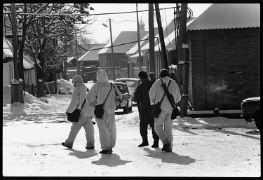 Chechen fighters in snow-white outfits in the mountain village of Shali, south-west of Grozny.