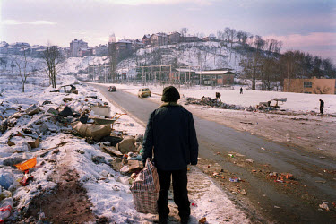 In sub-freezing temperatures ethnic Albanians scour through roadside rubbish dumps for food.
