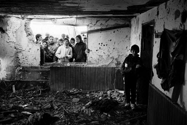 Young ethnic Albanians visit the destroyed home of Kosovo Liberation Army (KLA) leader Adem Jashari, who was killed along with 50 members of his family and village in one of the first massacres of the...