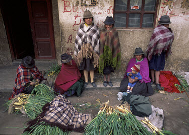 Quechua Indians selling leeks at market in Zumbahua.