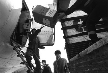 An aeroplane carrying foreign aid for Chechen refugees being unloaded at Ossetia Vladikavkaz. The plane brought water-cleaning equipment, clothes and medical supplies from Copenhagen, Denmark.