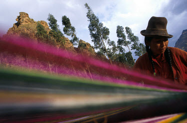 Quechua Indian woman weaving with dyed llama wool.
