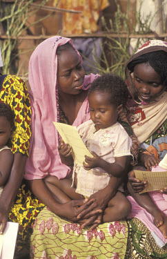 Mothers and children at an immunisation session in a health clinic.