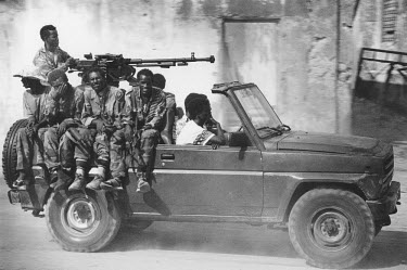 Gunmen loyal to Somali warlord General Mohamed Farrah Aidid (Aideed) cruise the streets in their �Technical', a converted pick-up truck with a heavy machine gun mounted on its back.