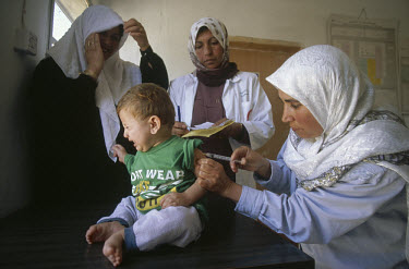 Immunising child at health clinic.