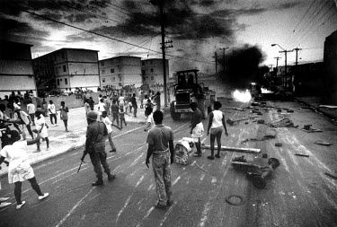 Tivoli Gardens, evening of an election day. JLP supporters, afraid of PNP violence, had erected road blocks which were then cleared by the Jamaican Defence Force.