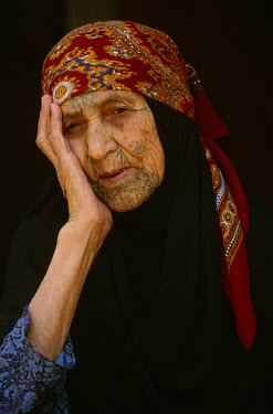 Elderly Bedouin woman with tattooed face.