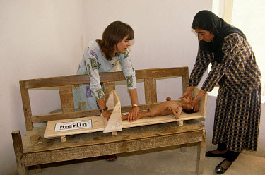 British nurse, working for the NGO Merlin, measuring a baby.