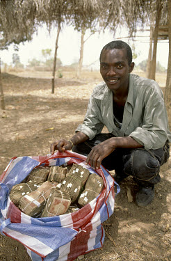 Man with bag of Le. 50,000. (approximately $250).