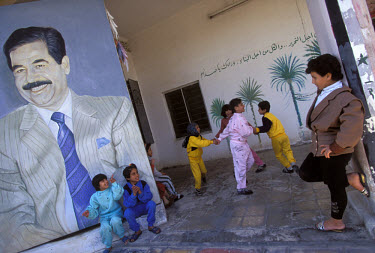 Children singing and dancing in praise of Saddam Hussein at an orphanage in Al Wiya.
