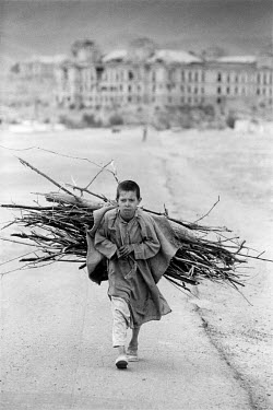 Boy collecting firewood.
