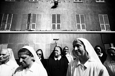 Nuns gather in a monastery to pray for world debt relief prior to the G8 summit and massive anti-globalisation demonstrations in the centre of the city.