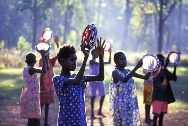 Teenage girls playing the tambourines and dancing at Ramingining. The local community was founded in the early 1970s and now has a population of 750, of which a third have chosen to live on outstation...