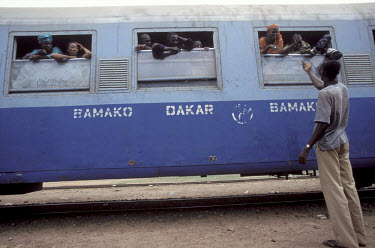 Passengers leaning out the window of the train from Bamako to Dakar in neighbouring Senegal.