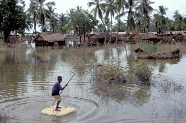 A boy on a makeshift polystyrene raft. His village was one of many in the Juba river basin to be flooded.