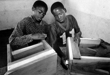 Boys doing woodwork in a Red Cross Day Centre for street children in the suburb of Xipamanine. They are given food as well as skills training.