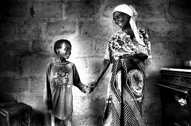 Susan with Frank, one of the five grandchildren she takes care of. She has seen three of her own children die of AIDS, including Frank's mother. Frank, 6, is himself seropositive for the AIDS virus. H...