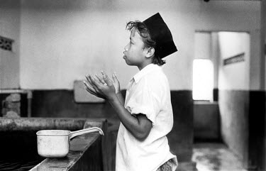 Young Muslim boy praying.