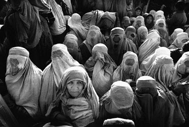 Women waiting for food distribution from Medecins Sans Frontieres (MSF). They receive a bag of wheat flour, a blanket and some soap. Despite the fall of the Taliban, most still prefer to wear the burq...