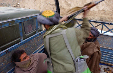 Close to the front line, a small group of Taliban prisoners of war have been sitting in a cold truck all day. The Northern Alliance are waiting to exchange them for the bodies of 11 of their dead comr...