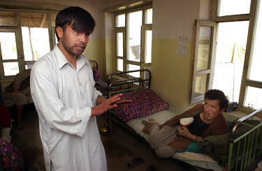 Dr Amrodien, an amputation specialist, with Muhammad, a Northern Alliance fighter who has lost an arm, in a hospital near the Kokcha front line. The doctor has performed 350 amputations in the last ye...