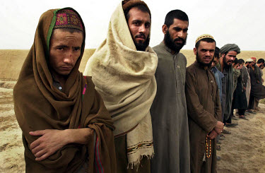 Captured Taliban soldiers held in a prison run by Commander Amon Qole of the Northern Alliance. The complex is guarded by teenage boys with machine guns.