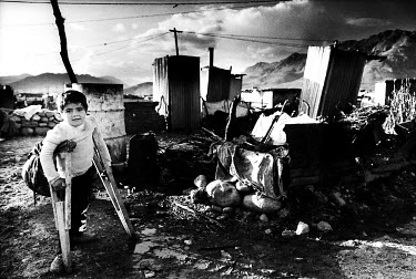 Young Kurdish boy on crutches. Displaced from Kirkuk, his community is now living in very poor conditions after being driven from their homes by the Iraqi army. They now live in the torture chambers o...