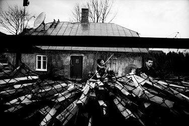 Two young inmates in a juvenile prison collecting wood for the boiler that heats a greenhouse just outside the prison wall. These jobs are only given to prisoners for good behaviour and just shortly b...