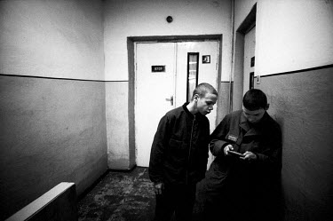 Inmates in a juvenile prison. Two boys in a corridor waiting to be counted for the third and last time before going to bed.