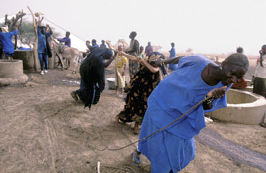 Tuareg people collecting water from a well.