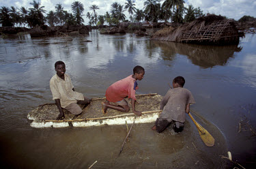 Flooding in the Juba river basin. Boys using a makeshift polystyrene boat to travel through their village.
