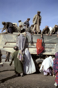Refugees living in Dasht-i-Qala load up family and possessions on to a truck to begin their journey home.  They will return to the village of Zaat Kamar, which had been the Northern Alliance front lin...