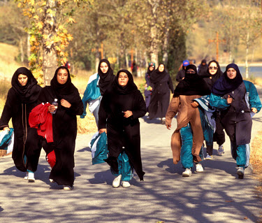 Women wearing the full hijab running a mini-marathon during National Sports Week.
