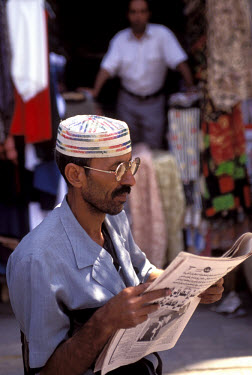 Man reading the newspaper in the Khan El Khalili bazaar.