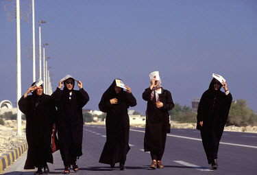 Women shielding themselves from the sun.