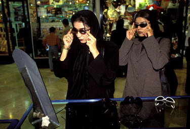 Women trying on sunglasses in a shopping centre in this duty-free port in the Persian Gulf.
