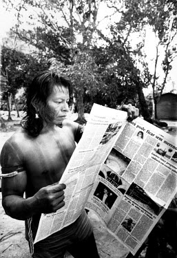 Indian man reading the newspaper.
