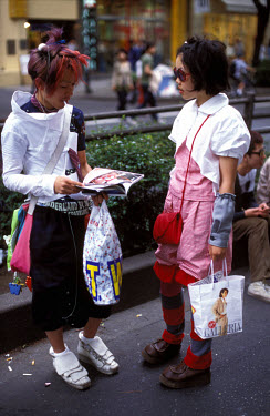 Teenage girls sporting the latest trends on Omote-sando Avenue, in the centre of the fashionable Harajuku district.