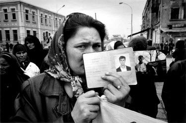 A Chechen woman showing the passports of her missing sons during a gathering of women searching for arrested and missing male relatives in central Grozny. Their protest was timed to coincide with Inte...