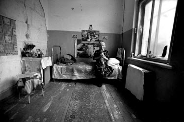 An elderly Russian woman, left homeless and alone when war broke out in Grozny, now living in a deserted old folks home. She worked in the Grozny train station for 23 years selling tickets. She has ad...