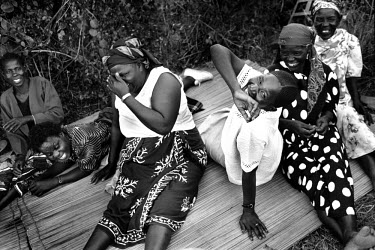The women of the Luo community giggle at the mention of condoms. Their husbands will not use them because they believe it will make their testicles grow. AIDS is epidemic in the tribe.