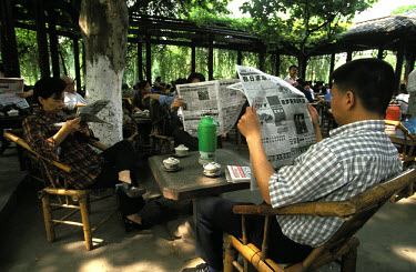 Reading newspapers in a tea house in Renmin Park.