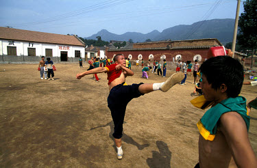 Shaolin. Martial arts school close to the famous temple. Kick training session.