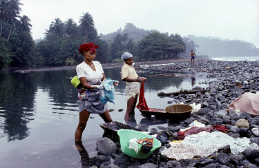 Mixed race women (Filhas de Terra) washing clothes near Praia des Pombas. The recent discovery of huge oil reserves in the Gulf of Guinea is set to make the  country one of the richest per capita in t...