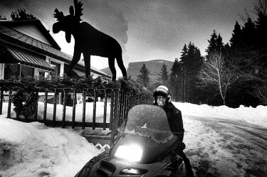 Outside the �Mainly Yours' bar in what locals call �moose-country". A forestry worker has just had breakfast and leaves for work on his snow-mobile. 2001 saw the harshest winter in Maine for over a hu...