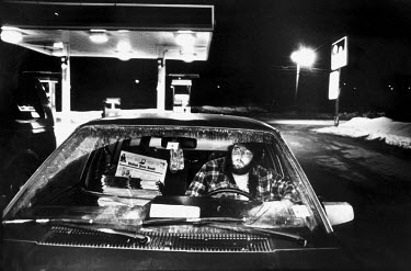 In the early hours of the morning, a newspaper delivery man is parked up at the Kingfield fuel stop. He drinks a coffee before he starts his circuit of the remote outlying districts of West Maine.