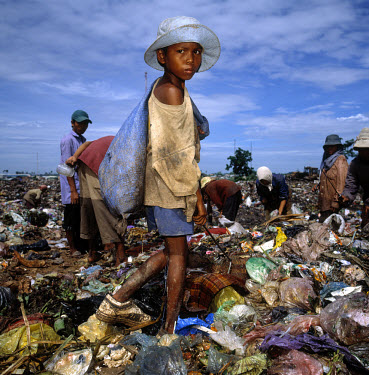 Children living and working on a rubbish dump, collecting metal and plastic to sell for recycling.