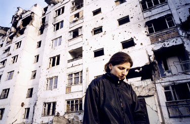 A Chechen woman ventures out from her home in a suburban tower block near the University district. In the second war, Russian forces bombed virtually every district of the town, destroying huge Soviet...