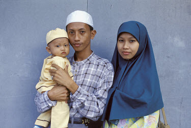 Young couple with their child in Kuching City.