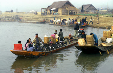 Nongdao. Boats loaded with people and goods departing from the Chinese border on the Ruili River to Burma. The long stretch of border between the two countries is extremely porous with guns, drugs and...